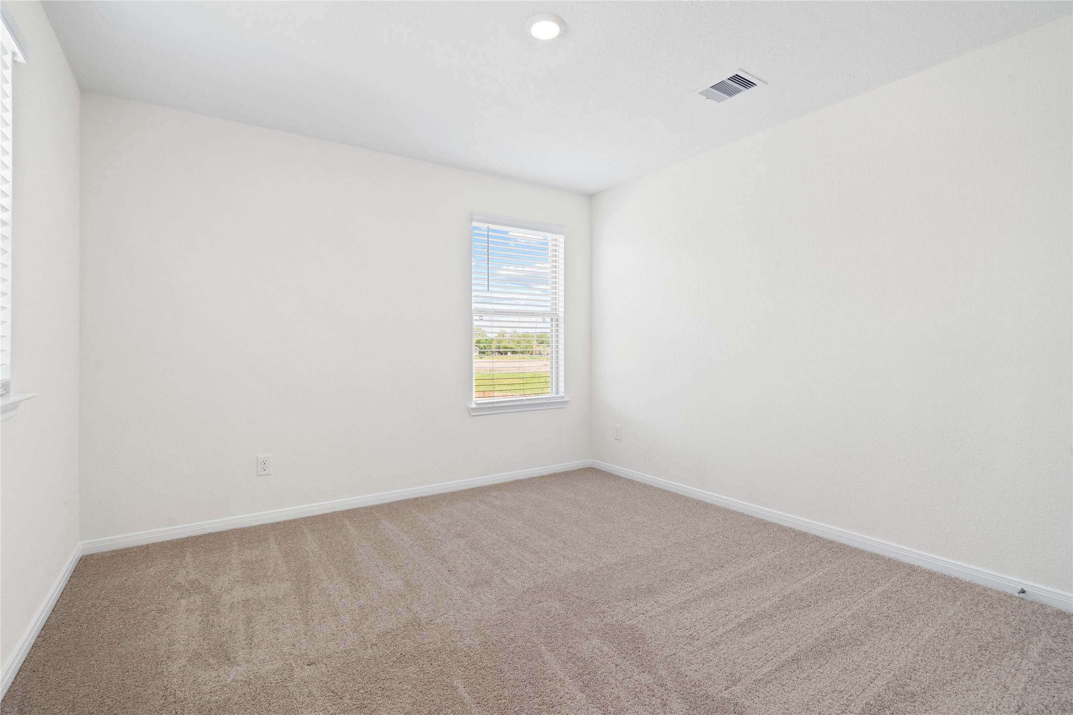 6403 Canby Court Rosharon, TX 77583 - Photo 15 of 23 This secondary bedroom combines comfort and style, featuring plush carpeting, neutral paint, recessed lighting, a large window with blinds, and a spacious closet.
