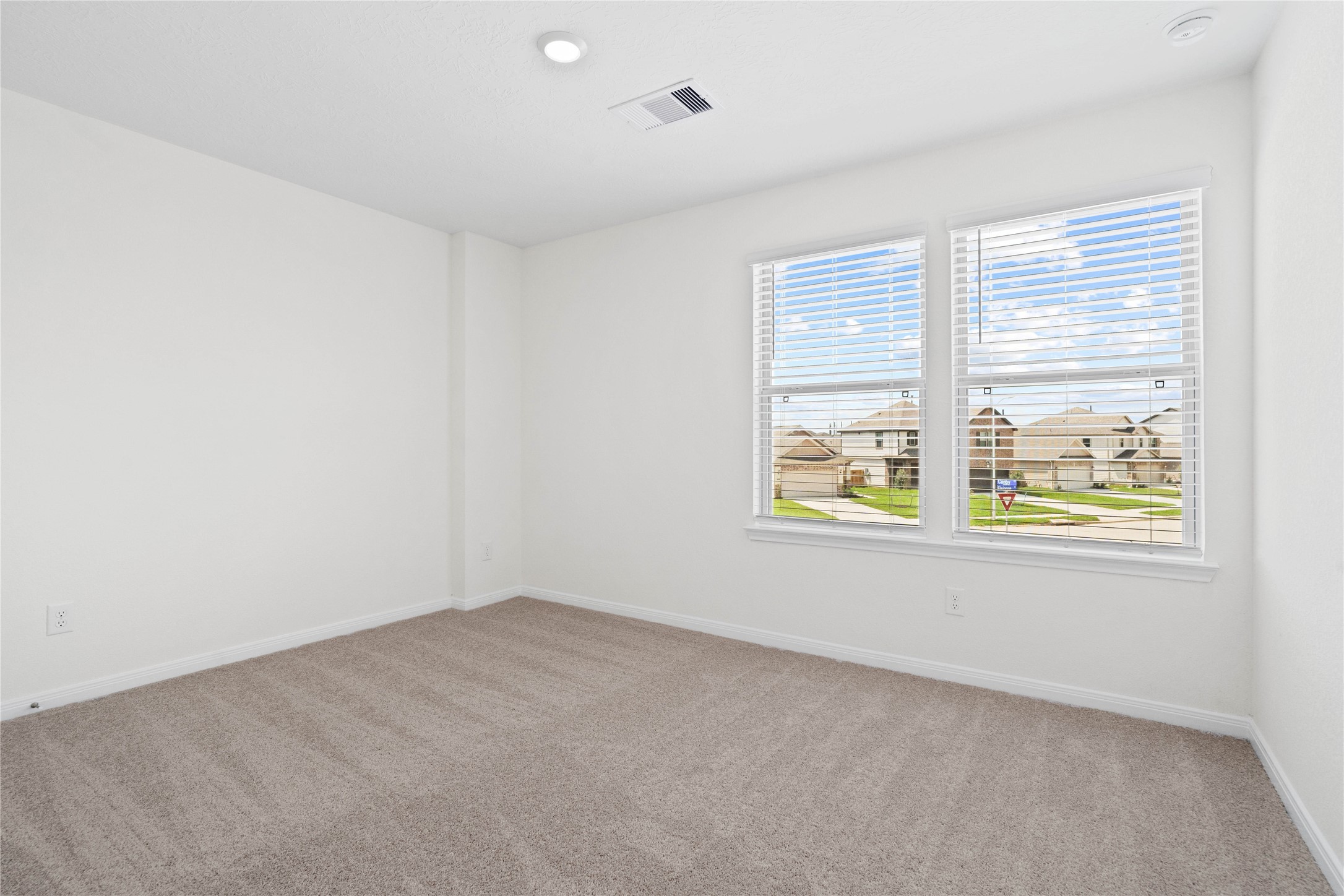 6403 Canby Court Rosharon, TX 77583 - Photo 17 of 23 This secondary bedroom combines comfort and style, featuring plush carpeting, neutral paint, recessed lighting, large windows with blinds, and a spacious closet.