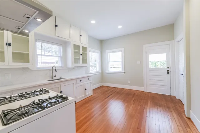 a kitchen with wooden floors and appliances