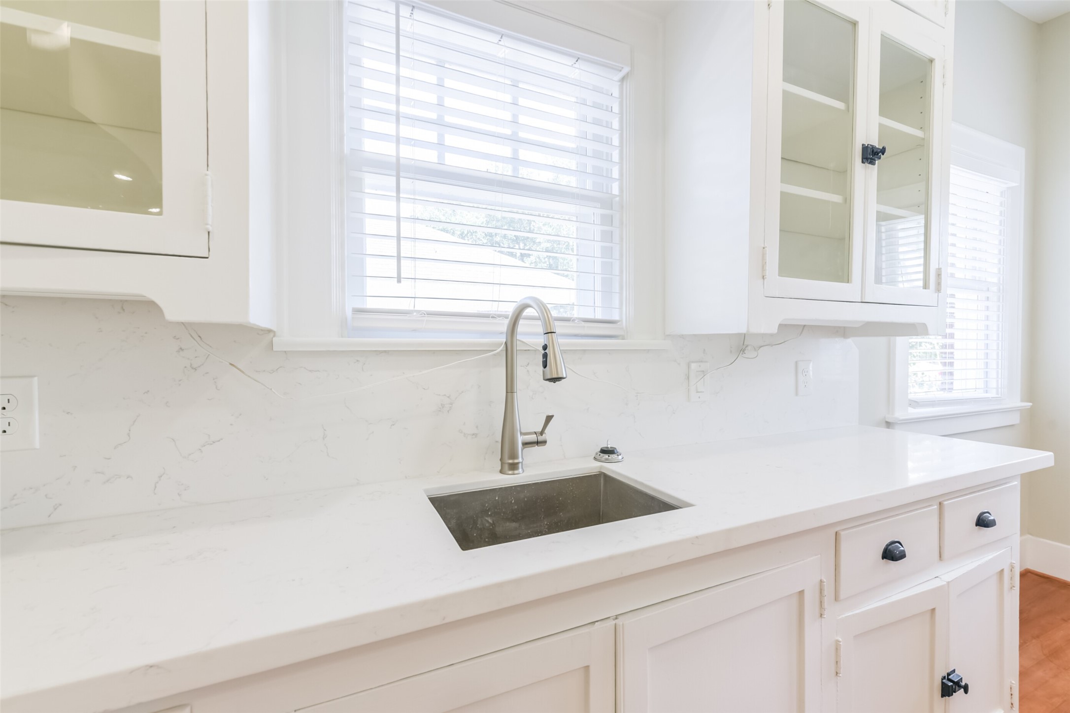 931 Teetshorn Street Houston, TX 77009 - Photo 18 of 25 a kitchen with white cabinets and a window