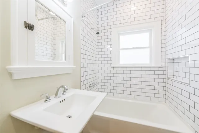 a white bath tub sitting next to a white sink