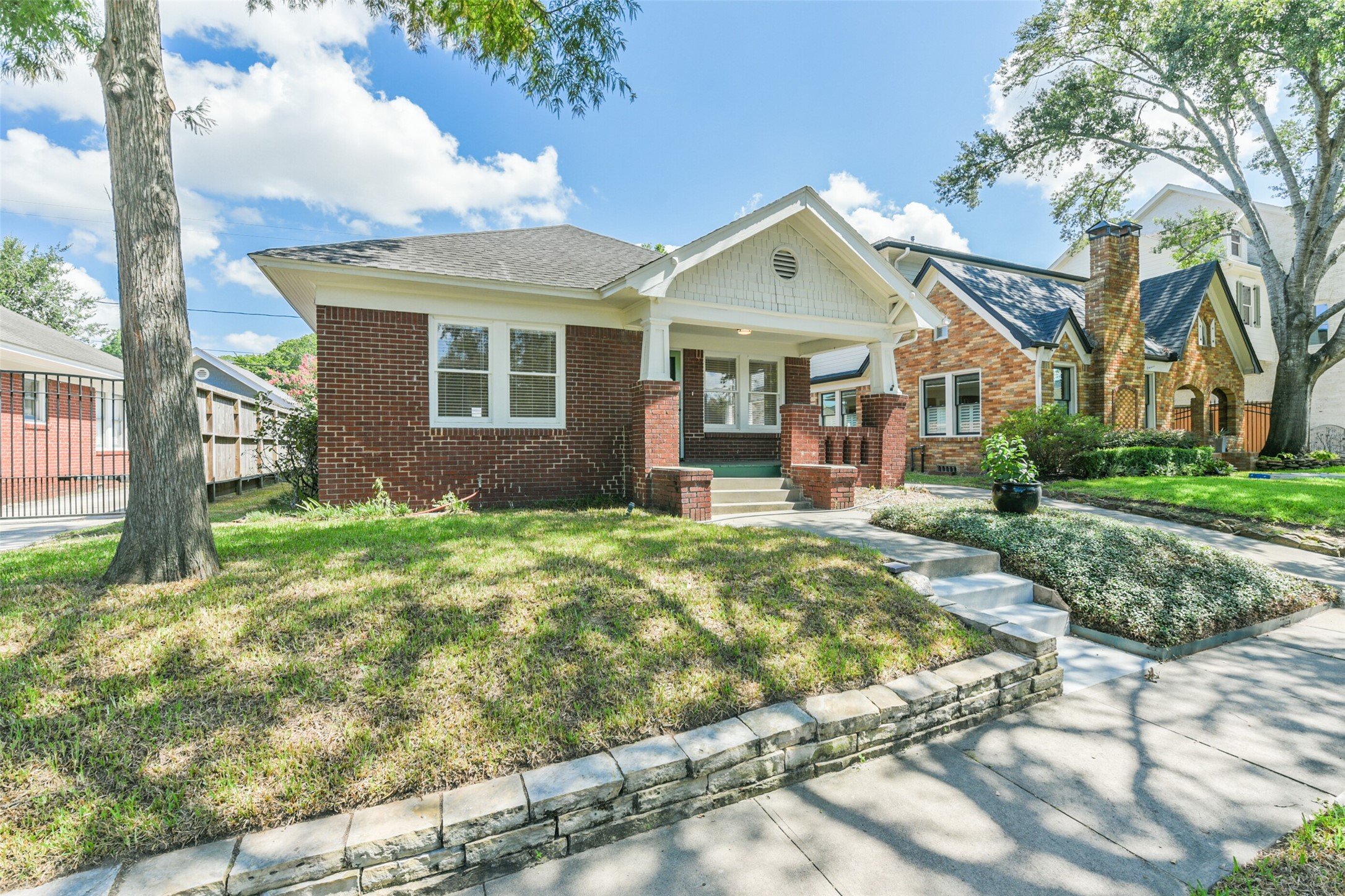 931 Teetshorn Street Houston, TX 77009 - Photo 3 of 25 a front view of a house with a yard and potted plants