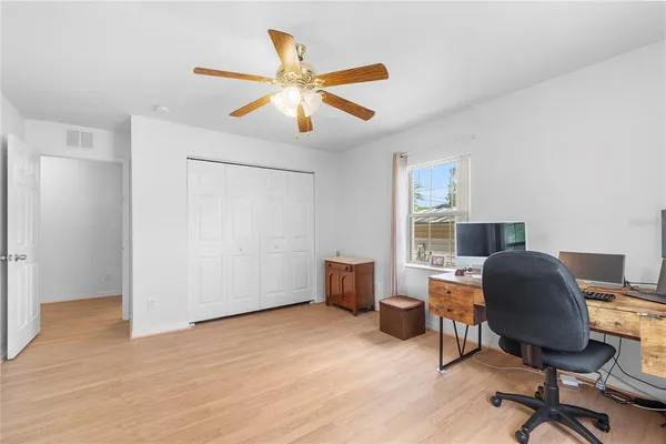 a workspace with wooden floor and a window