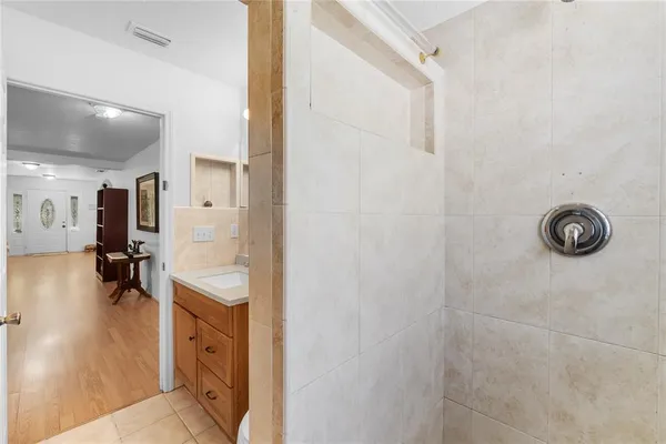 a view of a bathroom with tub mirror and sink
