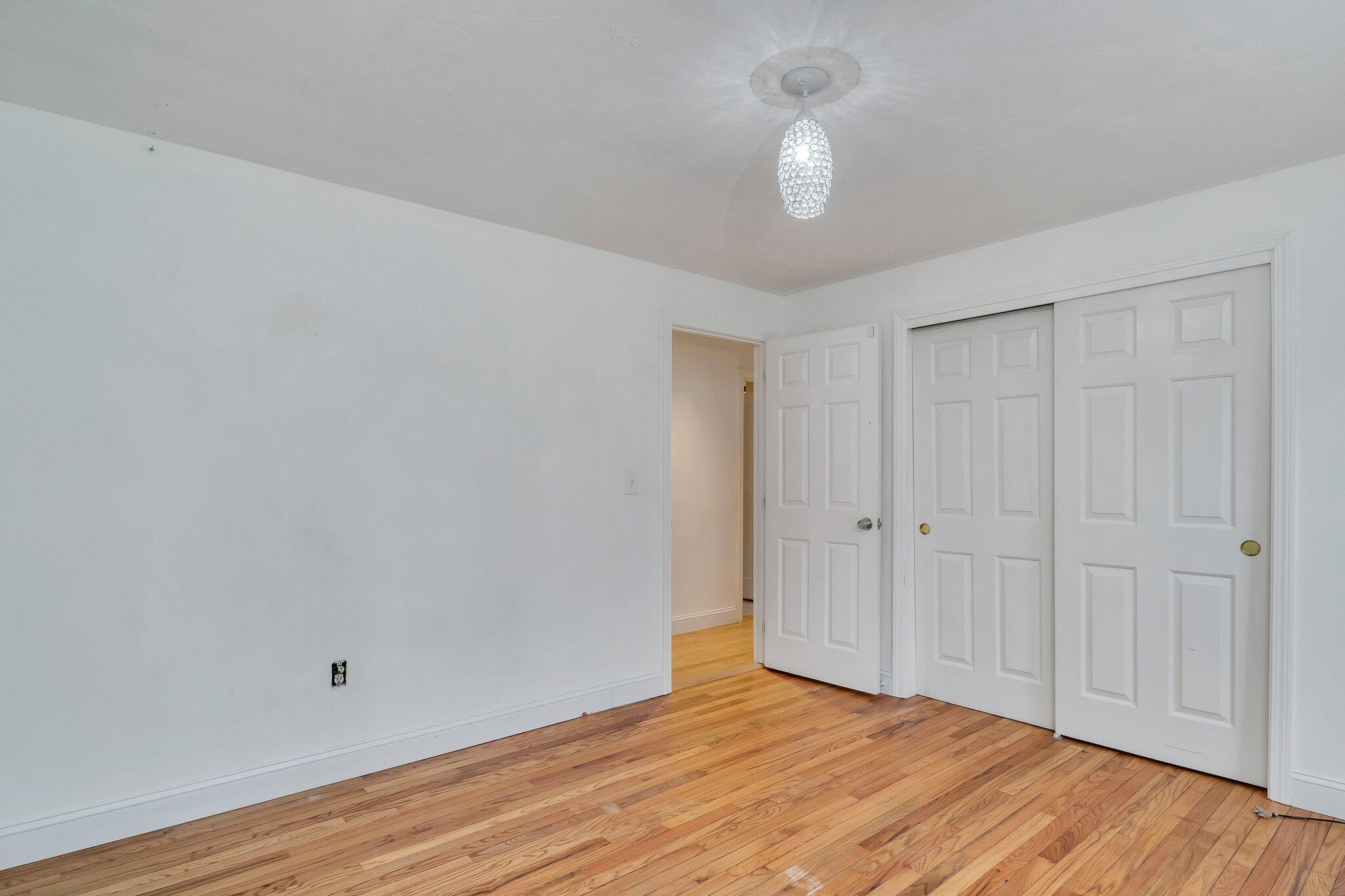 2 Windsor Way Mashpee, MA 02649 - Photo 18 of 53 a view of an empty room with wooden floor