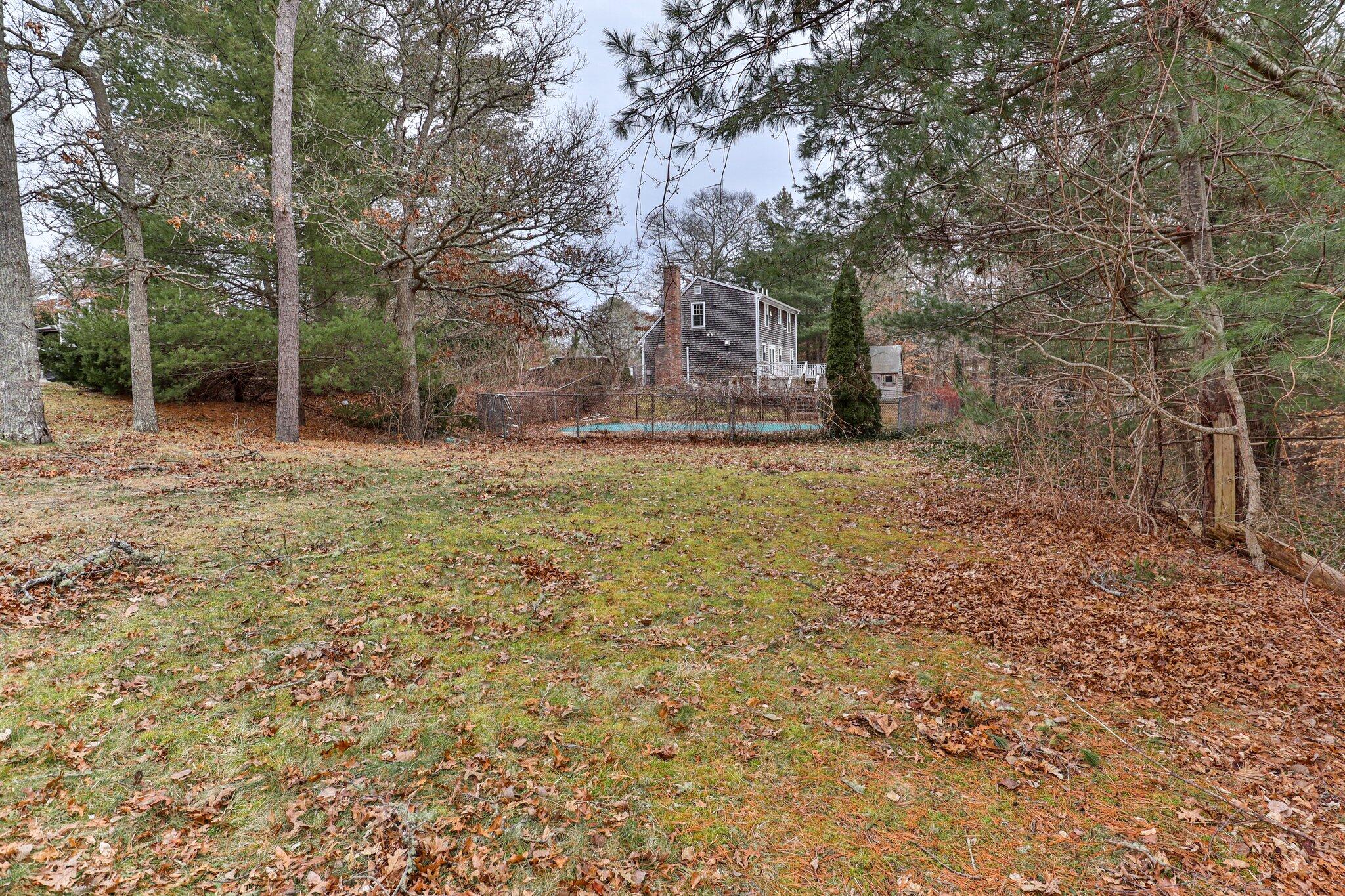 2 Windsor Way Mashpee, MA 02649 - Photo 3 of 53 a view of a backyard with large trees