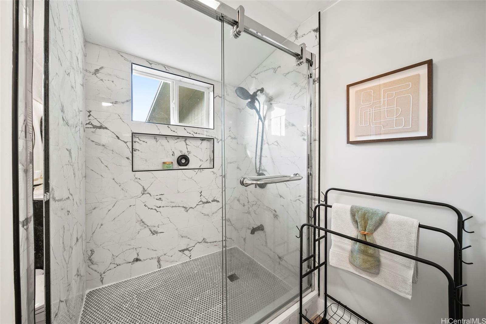 809 Hao Street Honolulu, HI 96821 - Photo 20 of 25 Walk-in shower with marble-style tile and frameless glass enclosure