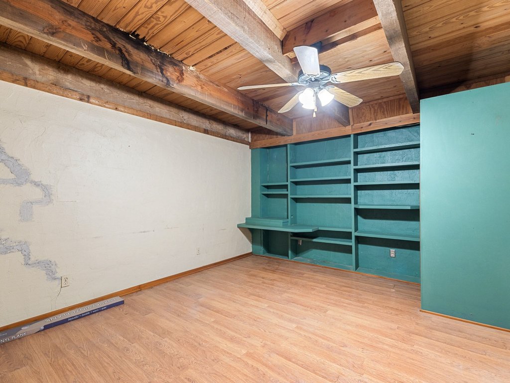 20416 Wilson Road Coupland, TX 78615 - Photo 11 of 39 Exposed ceiling beams and extensive built-in shelving define this versatile bonus space.