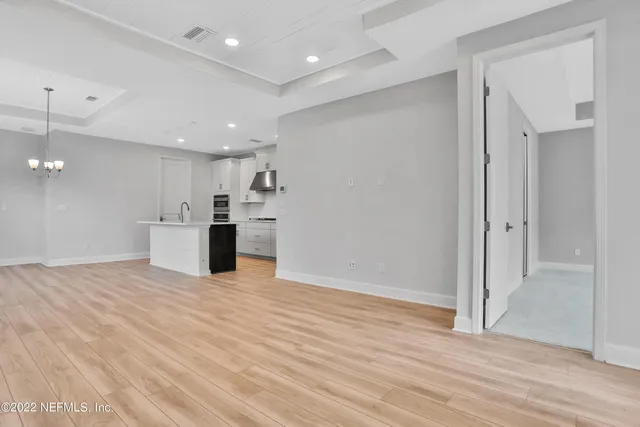 a view of a kitchen with a sink and a refrigerator