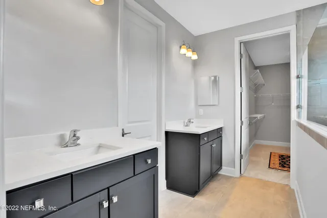 a spacious bathroom with a sink double vanity and a mirror