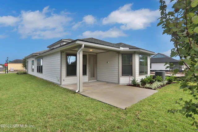 a front view of a house with a garden and yard
