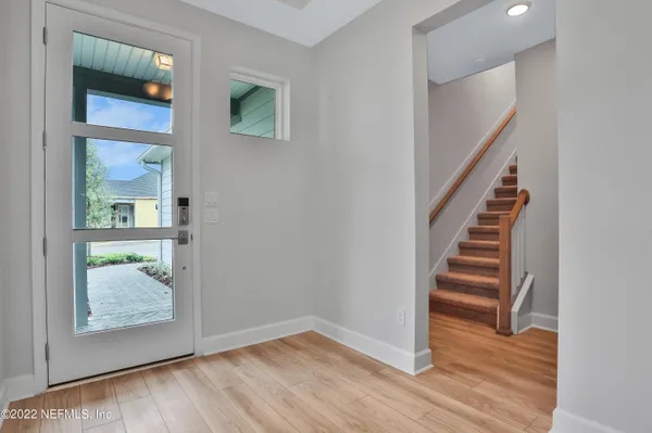 a view of entryway and hall with wooden floor