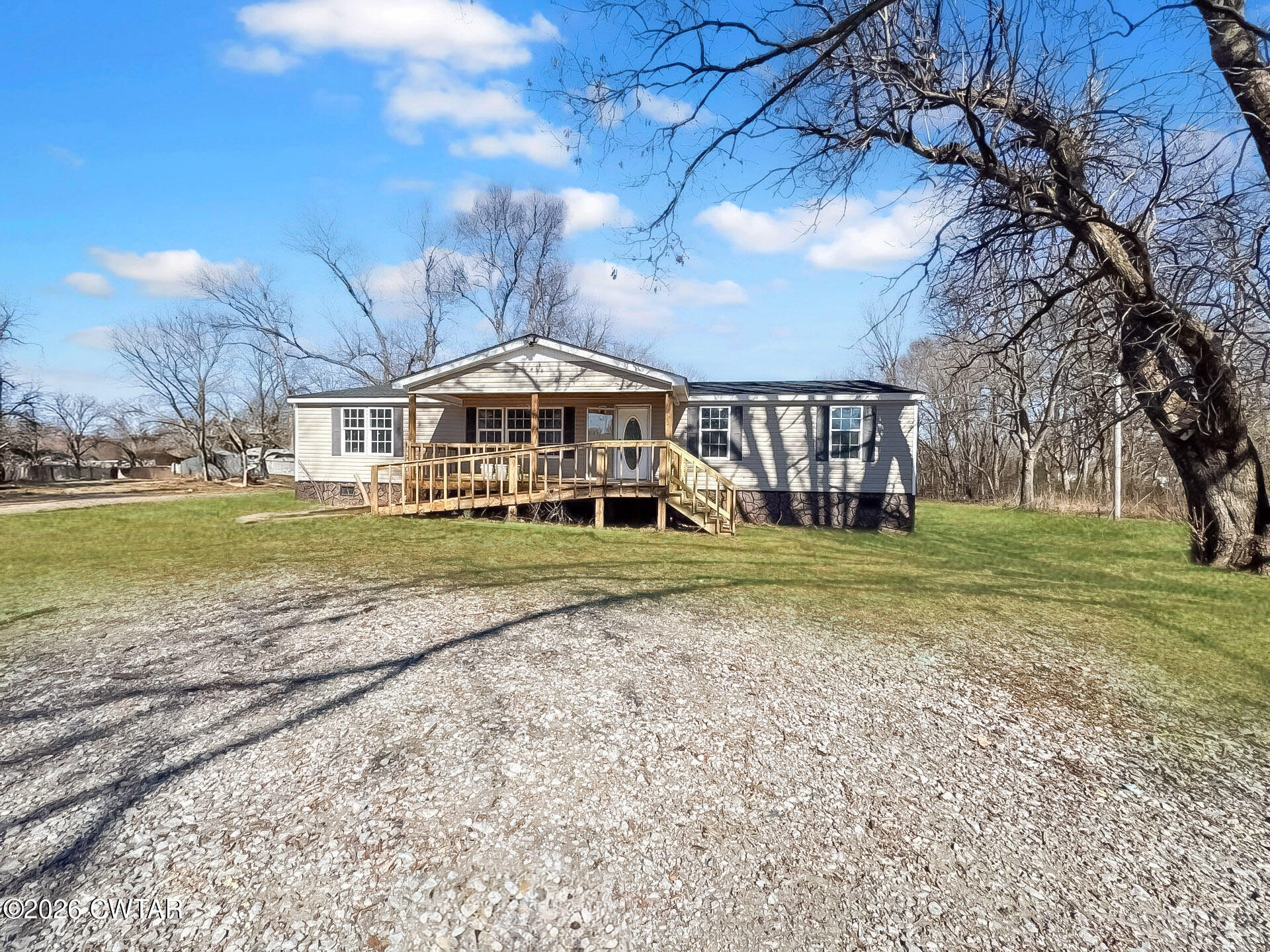 a view of a house with a yard and sitting area
