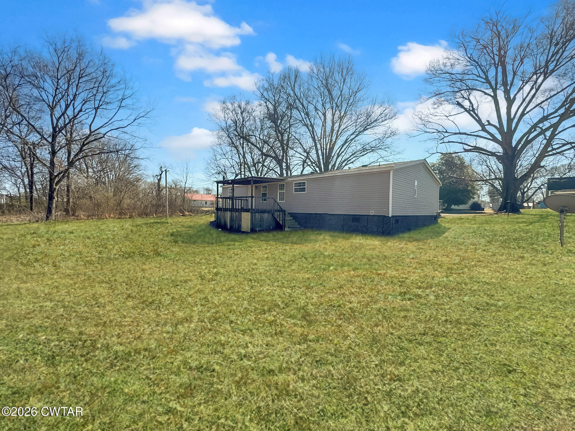643 Eaton Brazil Road Trenton, TN 38382 - Photo 11 of 13 a view of a yard with large trees