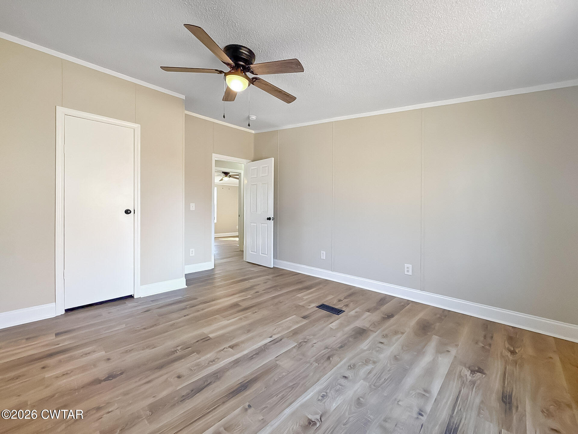 643 Eaton Brazil Road Trenton, TN 38382 - Photo 12 of 13 a view of an empty room with wooden floor