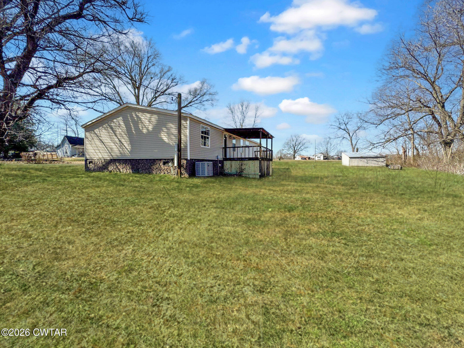 643 Eaton Brazil Road Trenton, TN 38382 - Photo 13 of 13 a view of a house with a yard
