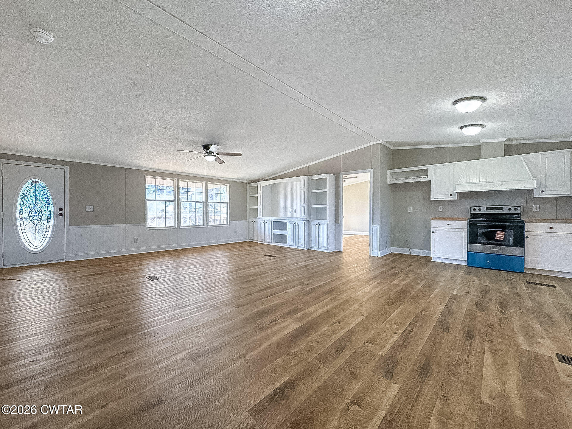 643 Eaton Brazil Road Trenton, TN 38382 - Photo 3 of 13 an empty room with wooden floor and windows