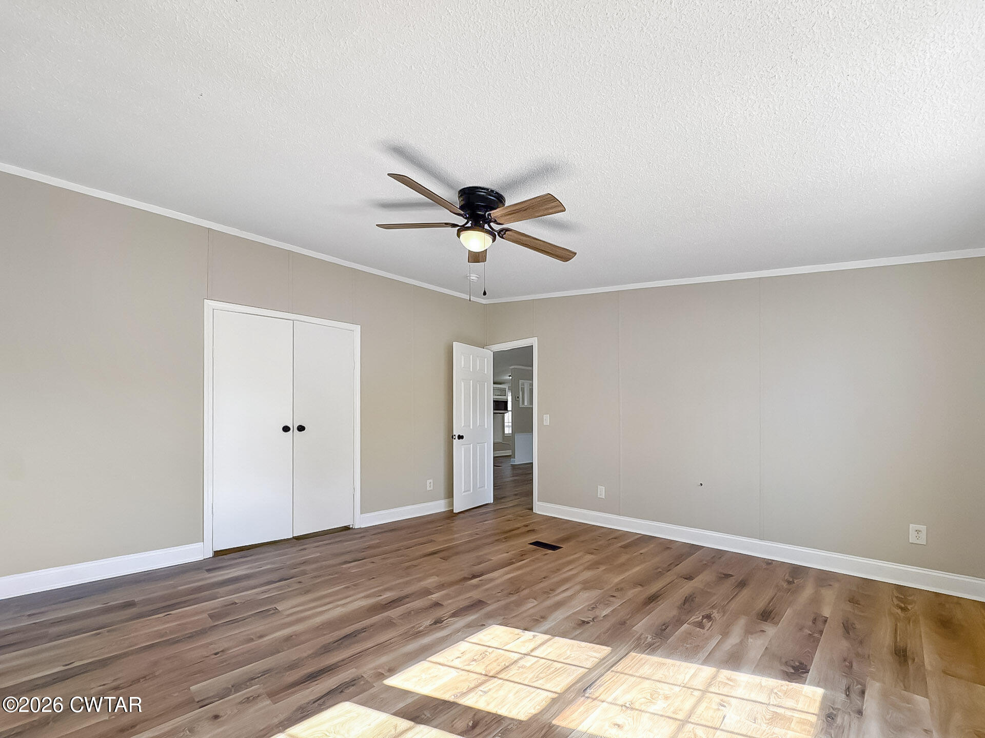 643 Eaton Brazil Road Trenton, TN 38382 - Photo 5 of 13 a view of a livingroom with a ceiling fan & hardwood floor