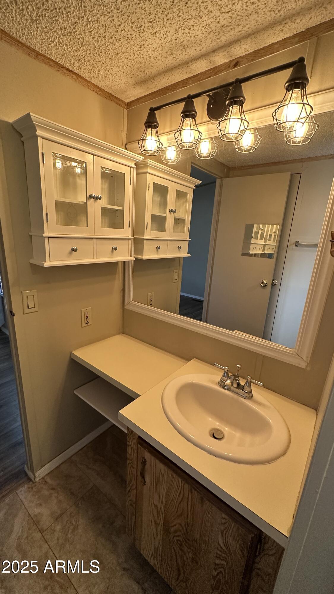 834 South Meridian Road, Unit 105 Apache Junction, AZ 85120 - Photo 15 of 48 a bathroom with a sink and a mirror