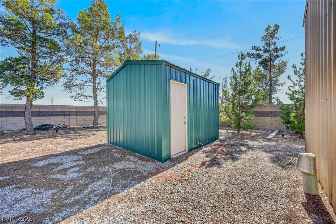 3780 South Ranger Way Pahrump, NV 89048 - Photo 46 of 57 A well-maintained well house shed offers convenient outdoor storage on this graveled lot.