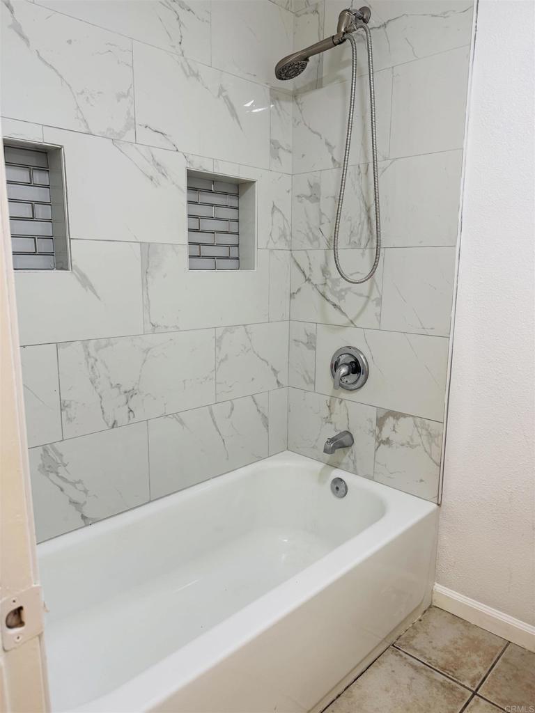 9170 Circulo Margen Spring Valley, CA 91977 - Photo 6 of 9 a bathroom with a bath tub with a shower