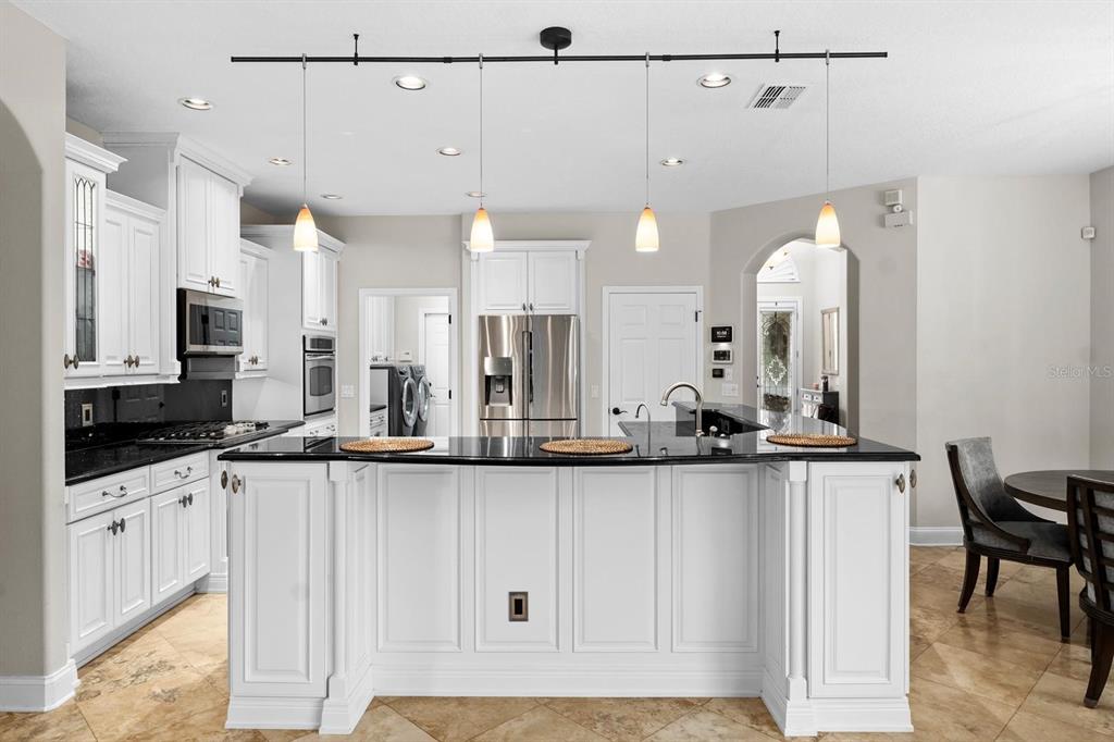 5614 Eagleglen Place Lithia, FL 33547 - Photo 12 of 35 a kitchen with stainless steel appliances granite countertop a sink and cabinets