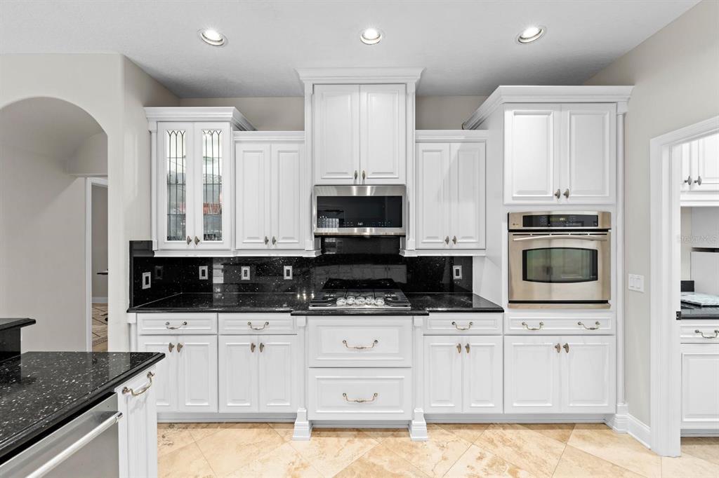 5614 Eagleglen Place Lithia, FL 33547 - Photo 13 of 35 a kitchen with granite countertop a sink a stove and cabinets
