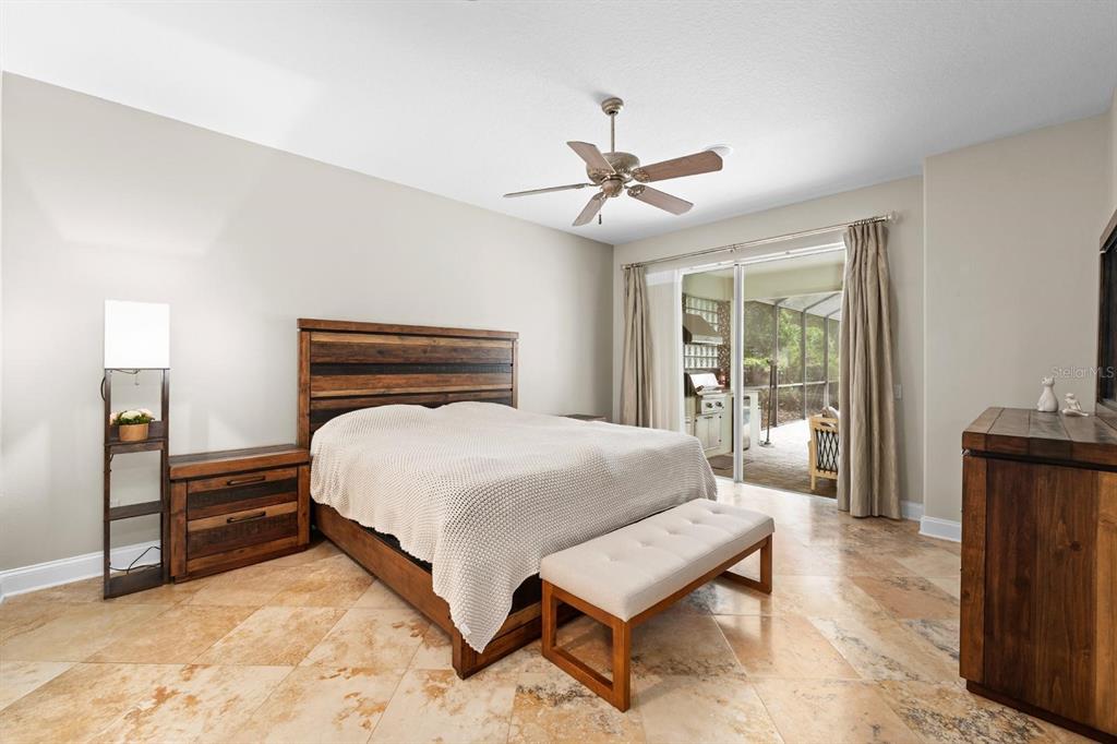 5614 Eagleglen Place Lithia, FL 33547 - Photo 15 of 35 a bedroom with a bed and wooden floor