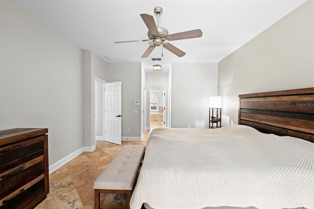 5614 Eagleglen Place Lithia, FL 33547 - Photo 16 of 35 a bedroom with a bed and a chandelier