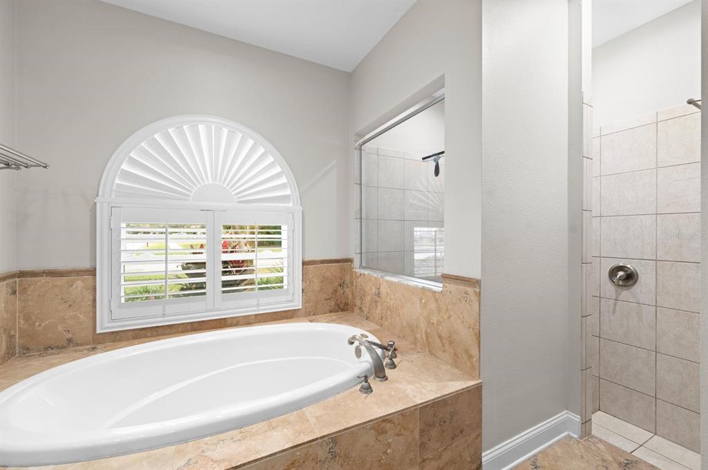 5614 Eagleglen Place Lithia, FL 33547 - Photo 18 of 35 a bathroom with a tub a sink and a window