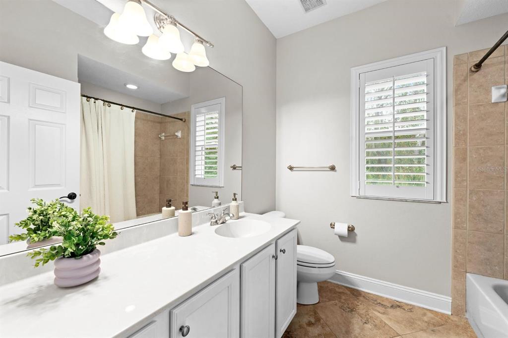 5614 Eagleglen Place Lithia, FL 33547 - Photo 20 of 35 a bathroom with a sink a toilet and a mirror