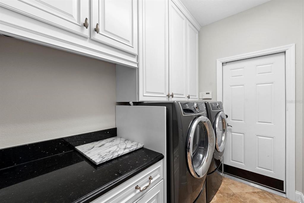 5614 Eagleglen Place Lithia, FL 33547 - Photo 24 of 35 a utility room with dryer and washer