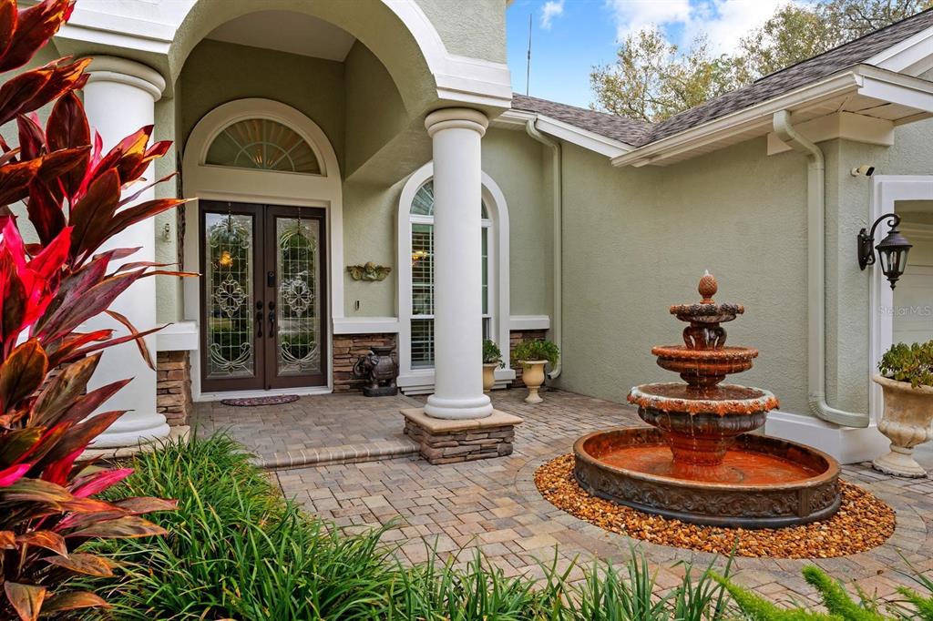 5614 Eagleglen Place Lithia, FL 33547 - Photo 4 of 35 a front view of a house with fountain