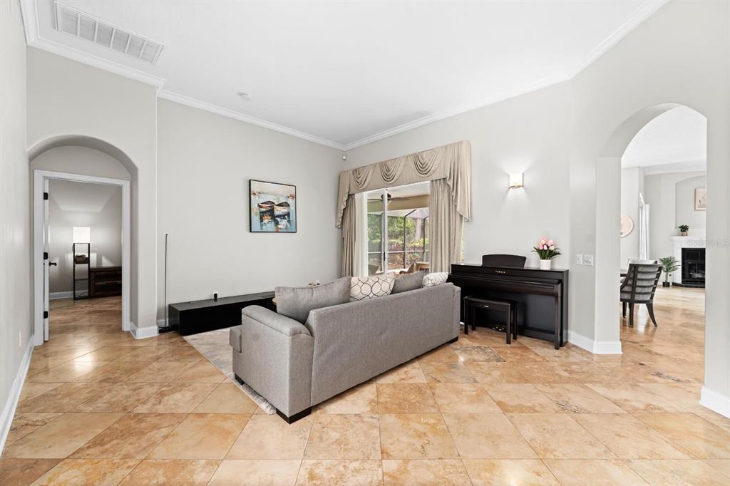 5614 Eagleglen Place Lithia, FL 33547 - Photo 5 of 35 a living room with furniture and a dining table next to a window