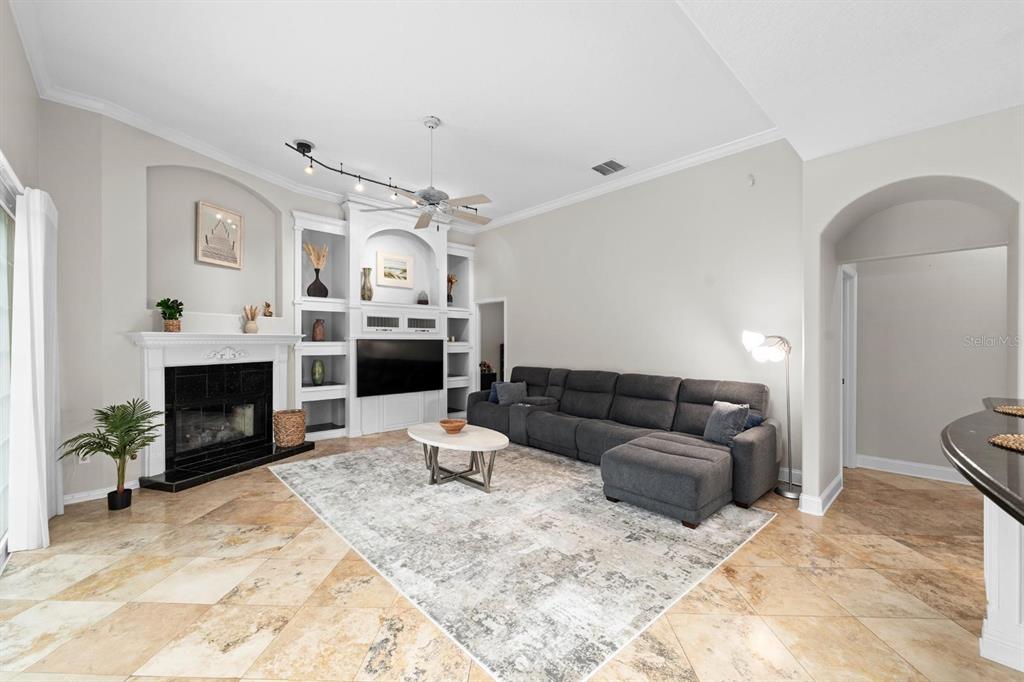 5614 Eagleglen Place Lithia, FL 33547 - Photo 6 of 35 a living room with furniture and a fireplace