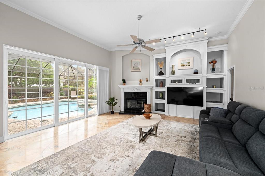 5614 Eagleglen Place Lithia, FL 33547 - Photo 7 of 35 a living room with furniture a fireplace and a flat screen tv