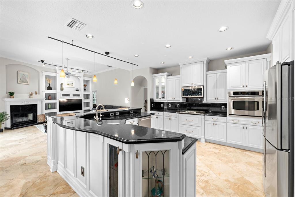 5614 Eagleglen Place Lithia, FL 33547 - Photo 10 of 35 a kitchen with stainless steel appliances granite countertop a sink a stove top oven a counter space and cabinets