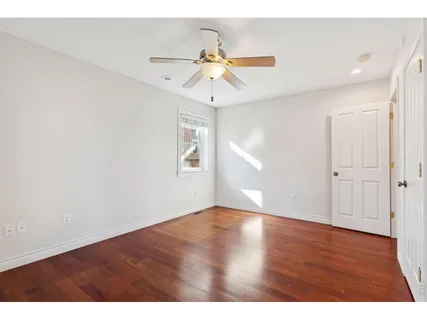 a front view of a house with a yard and green space