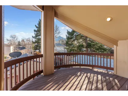 an aerial view of a house with a yard and large trees