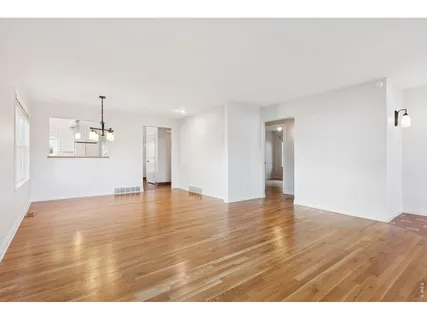 a kitchen with cabinets and wooden floor