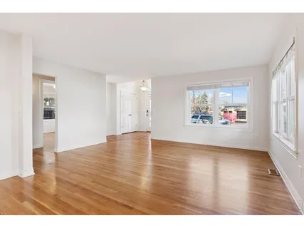 a kitchen with cabinets and wooden floor