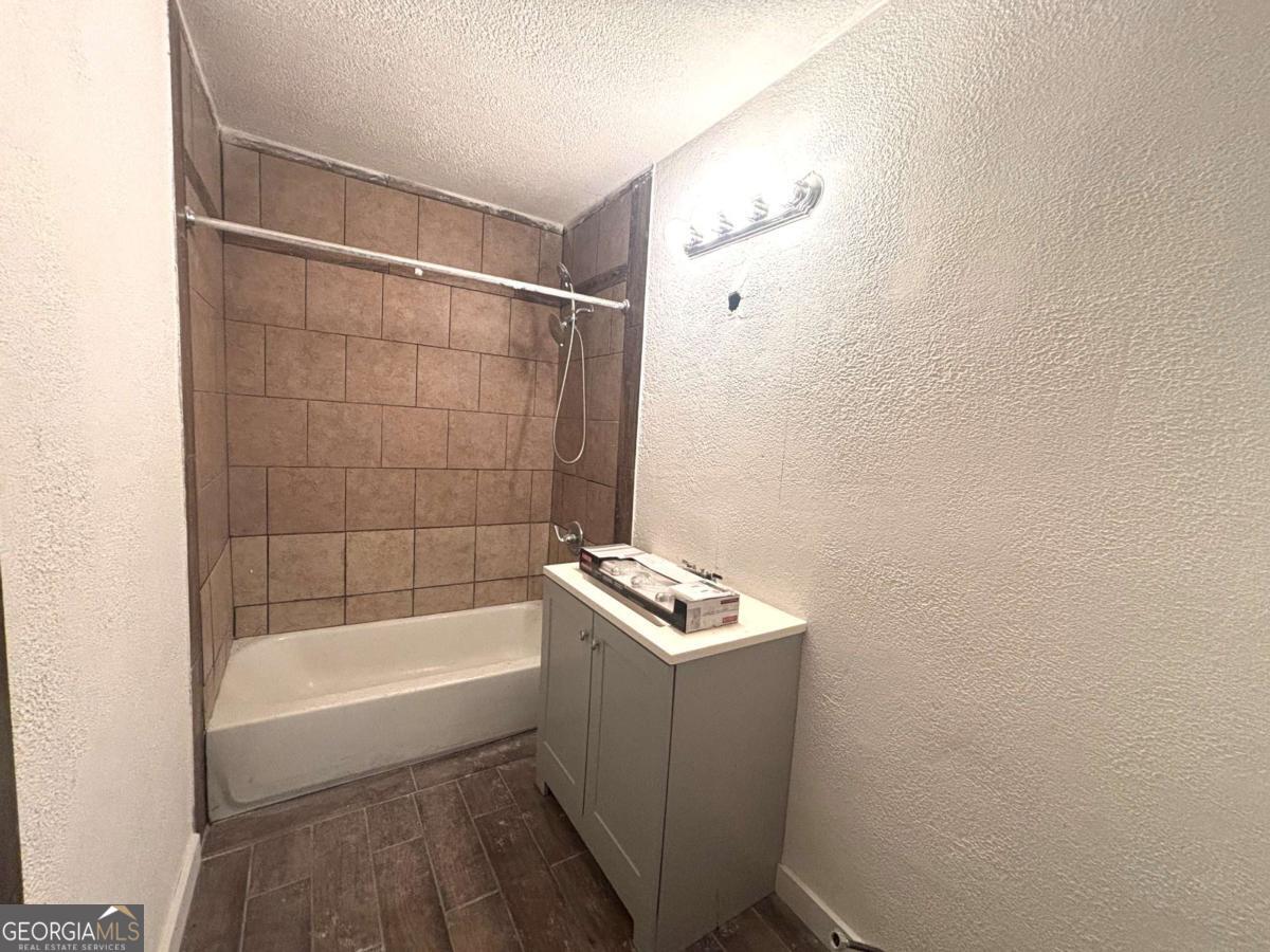 1001 Alpine Court Athens, GA 30606 - Photo 6 of 9 a bathroom with a bathtub a toilet and a shower