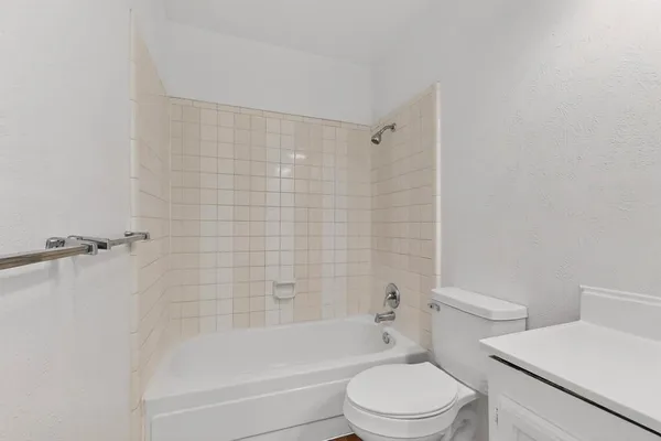 a bathroom with a toilet and a bath tub