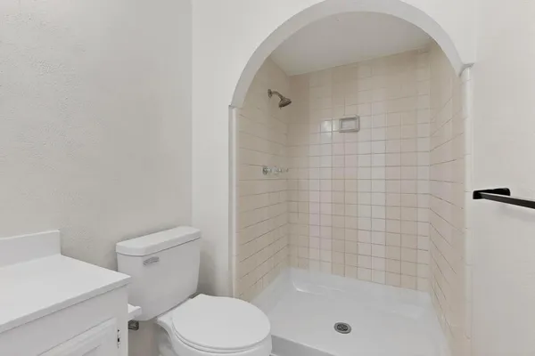 a bathroom with a shower a toilet and a sink