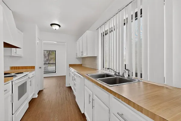 a kitchen with stainless steel appliances a sink and stove