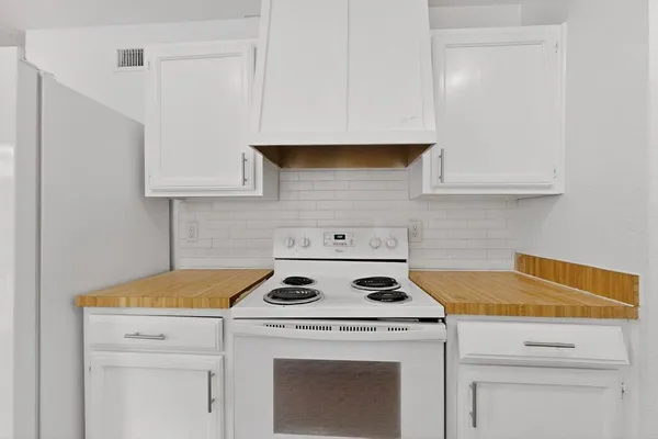 a stove top oven sitting inside of a kitchen