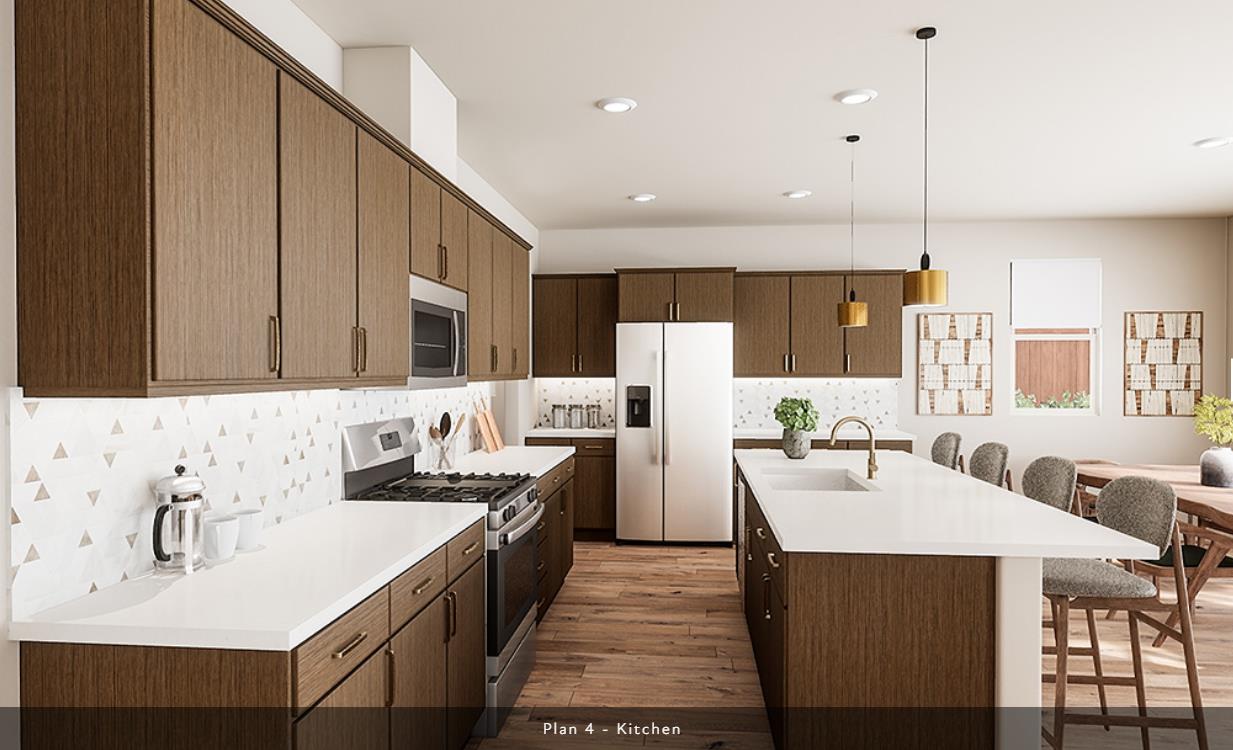 527 Willow Bend Lathrop, CA 95330 - Photo 4 of 22 a kitchen with a sink a stove and chairs