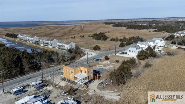 an aerial view of a house with a lake view