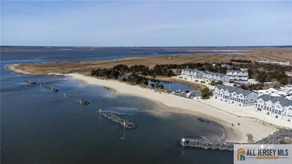 an aerial view of a house with a ocean