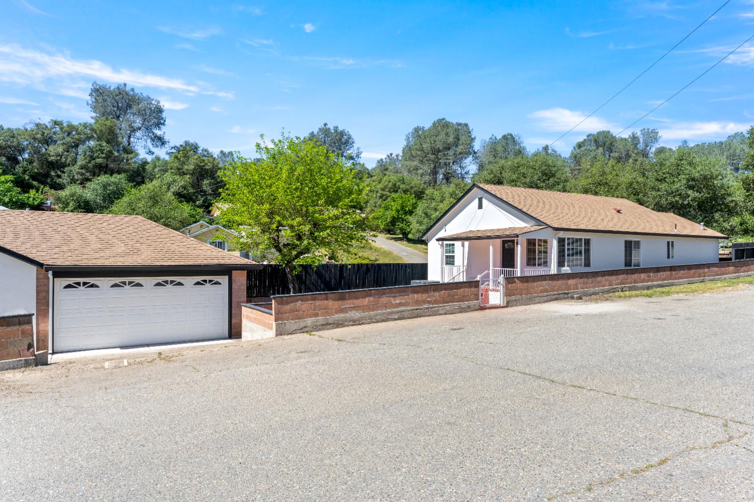 185 Mill Street Sutter Creek, CA 95685 - Photo 15 of 77 a front view of a house with a yard and garage